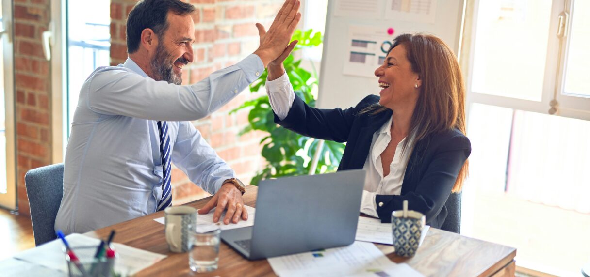 Two business professionals discussing Shopify Plus development strategy