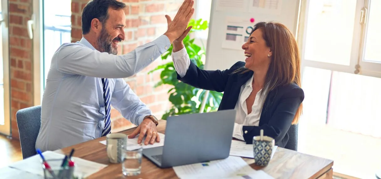 Two business professionals discussing Shopify Plus development strategy