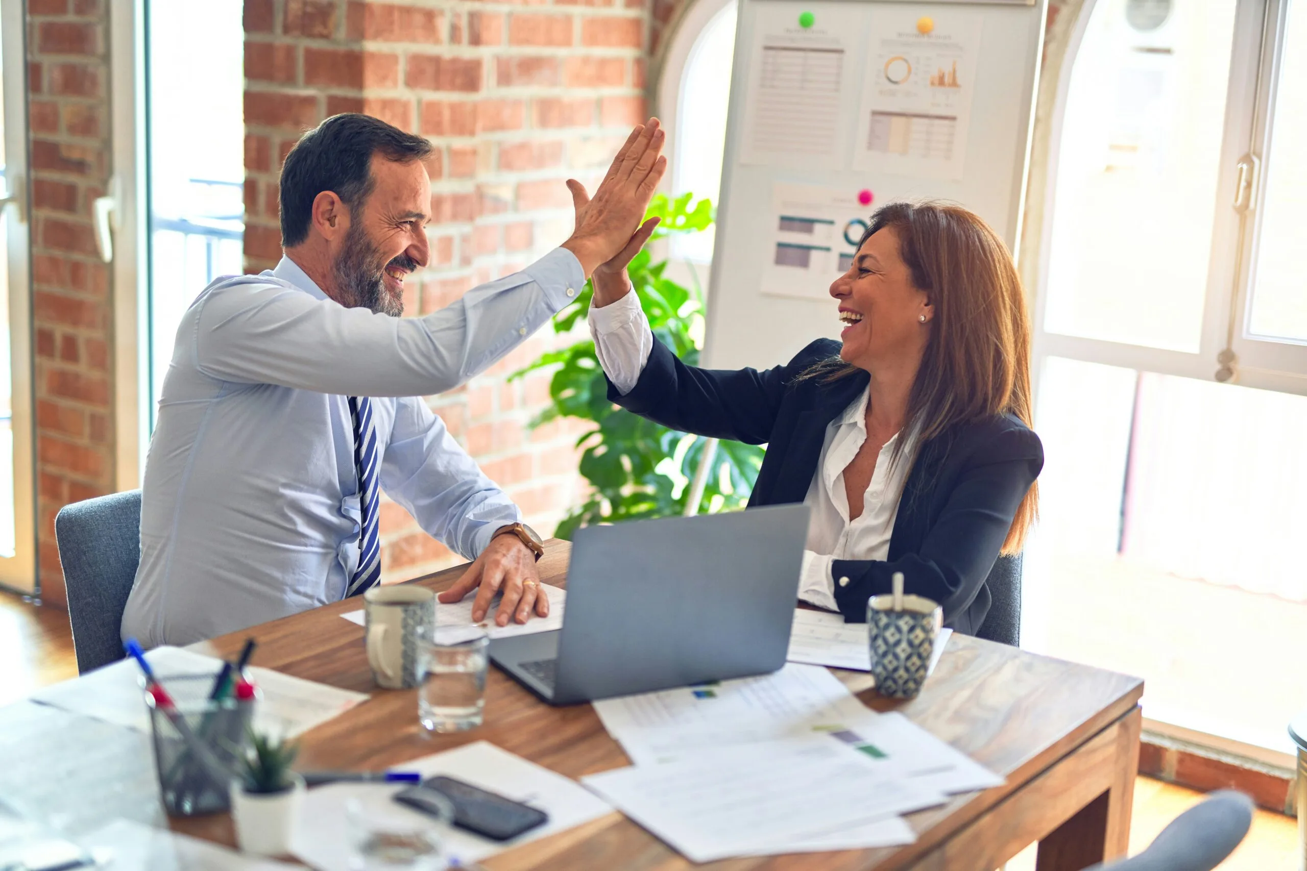 Two business professionals discussing Shopify Plus development strategy