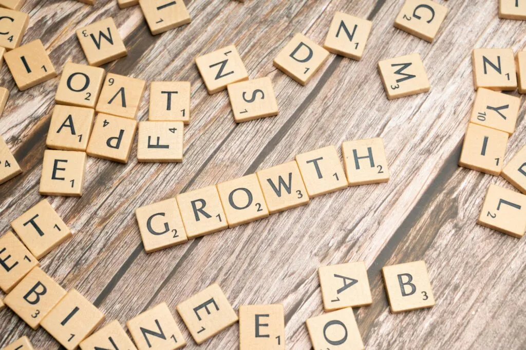 Scrabble tiles spelling GROWTH — scaling with Shopify Plus development