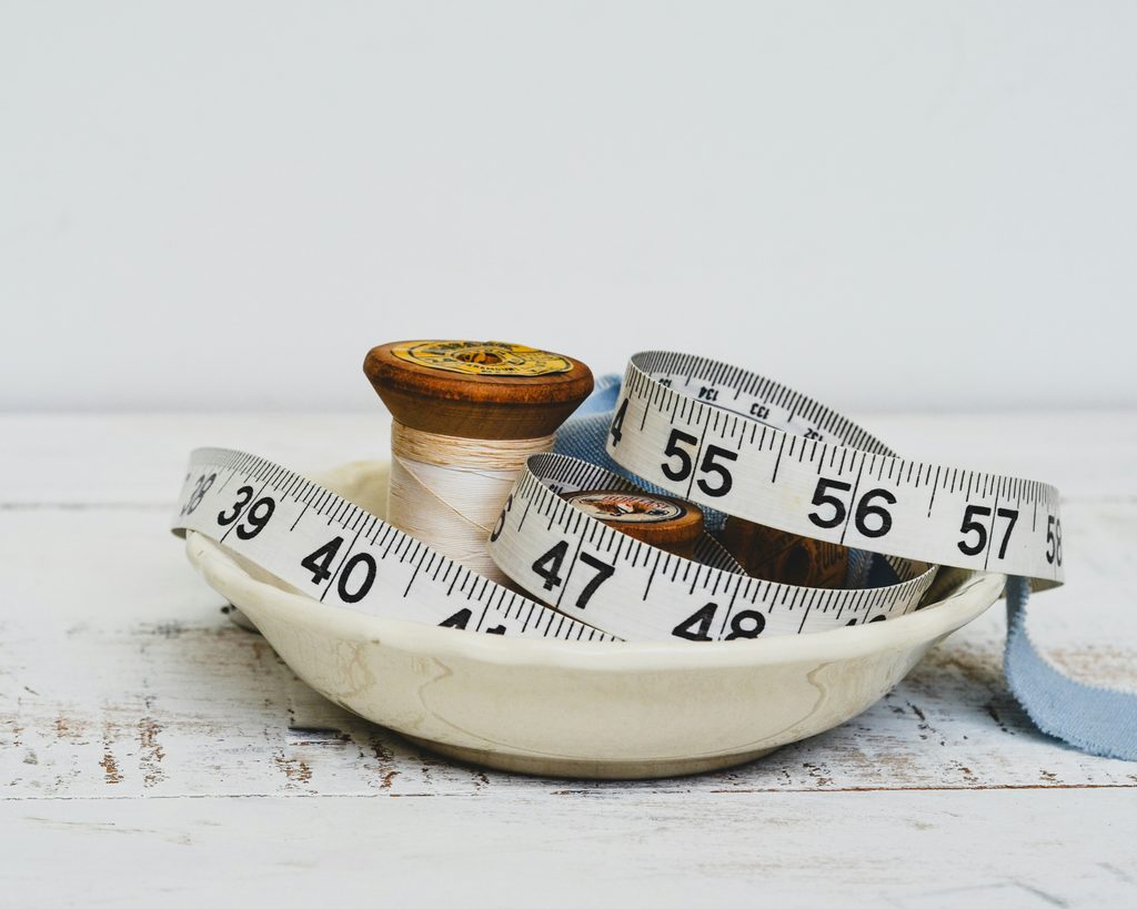 Measuring tape and thread spools for fashion product sizing