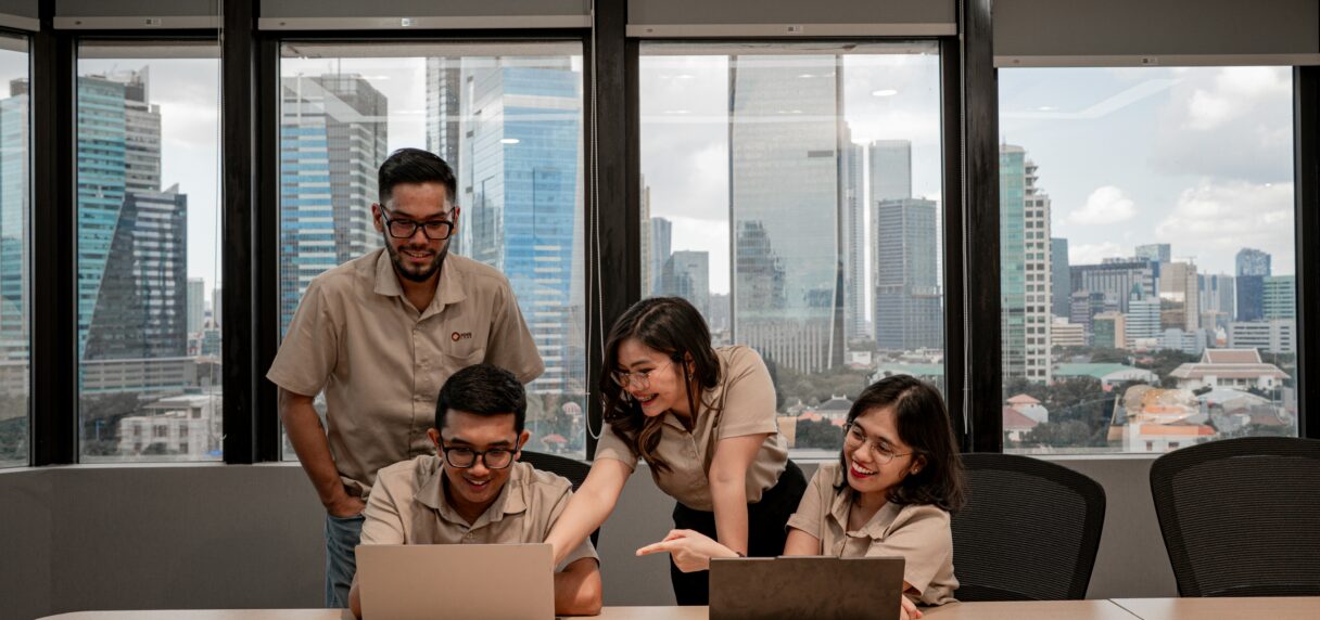 Ecommerce team comparing BigCommerce and Shopify on two laptops