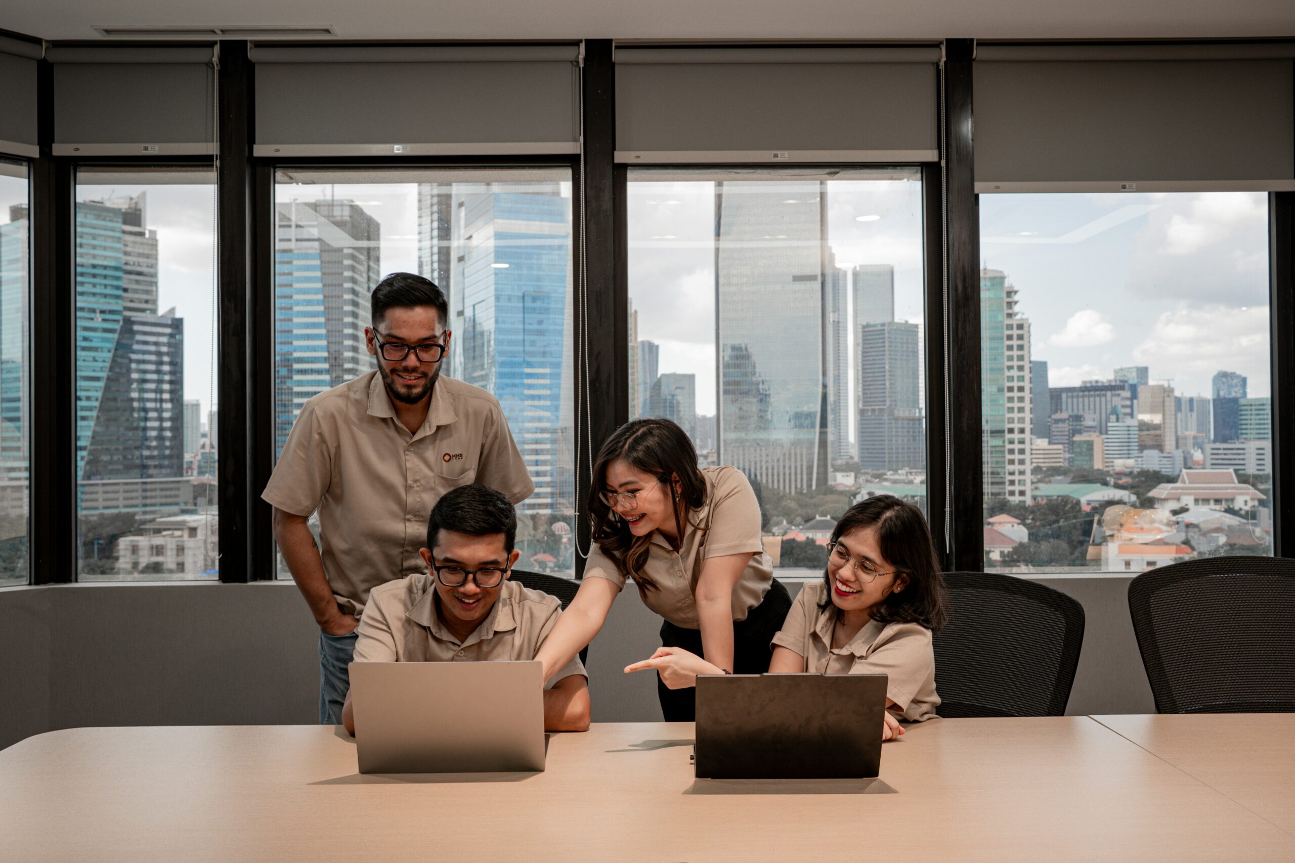 Ecommerce team comparing BigCommerce and Shopify on two laptops